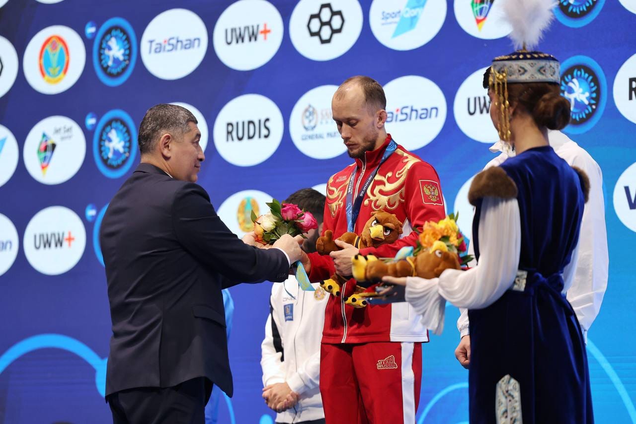 Жеңімпаз спортшыға гүл мен ойыншық сыйлап жатқан сәт.