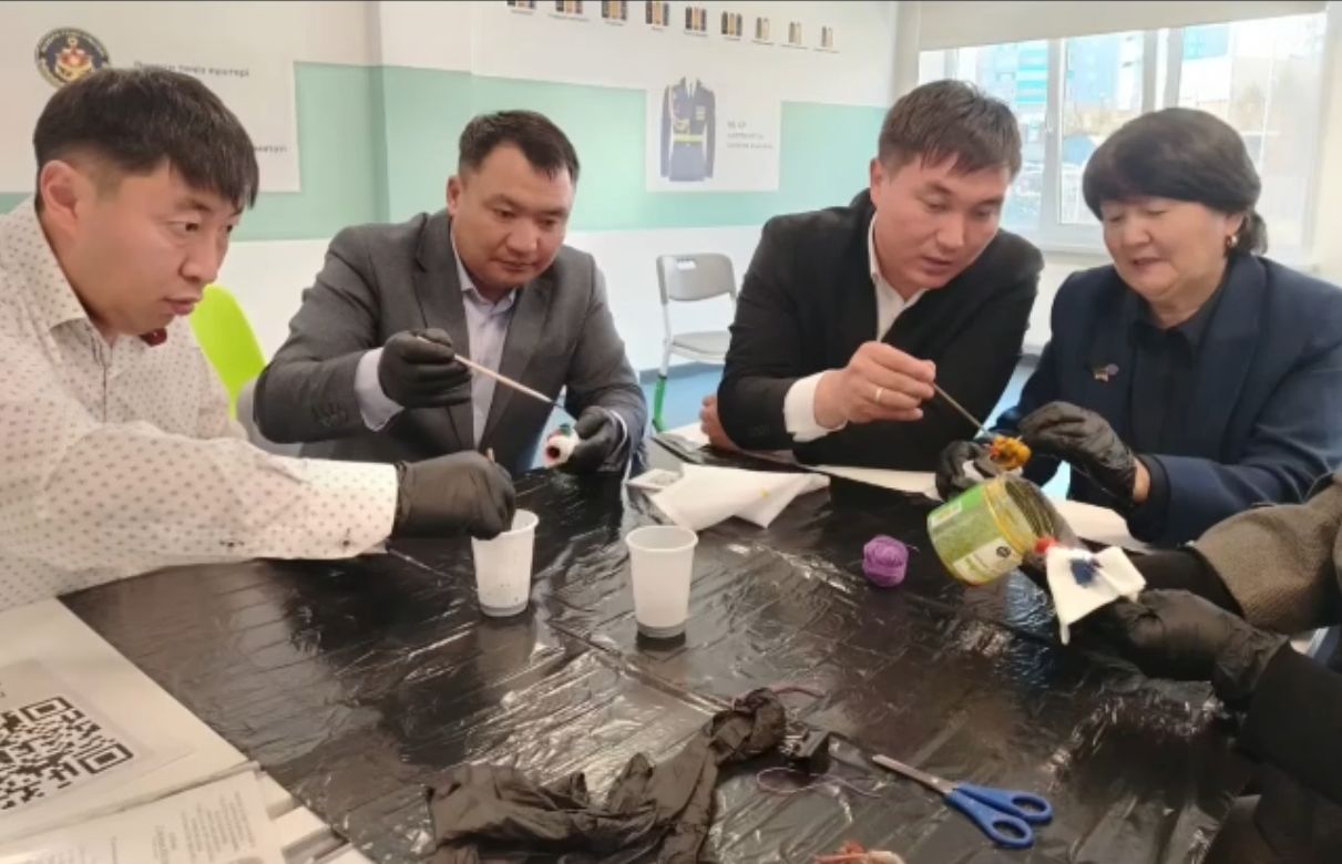 Зертханада қоршаған ортаны қорғау бойынша тәжірибе жасап жатқан адамдар тобы.